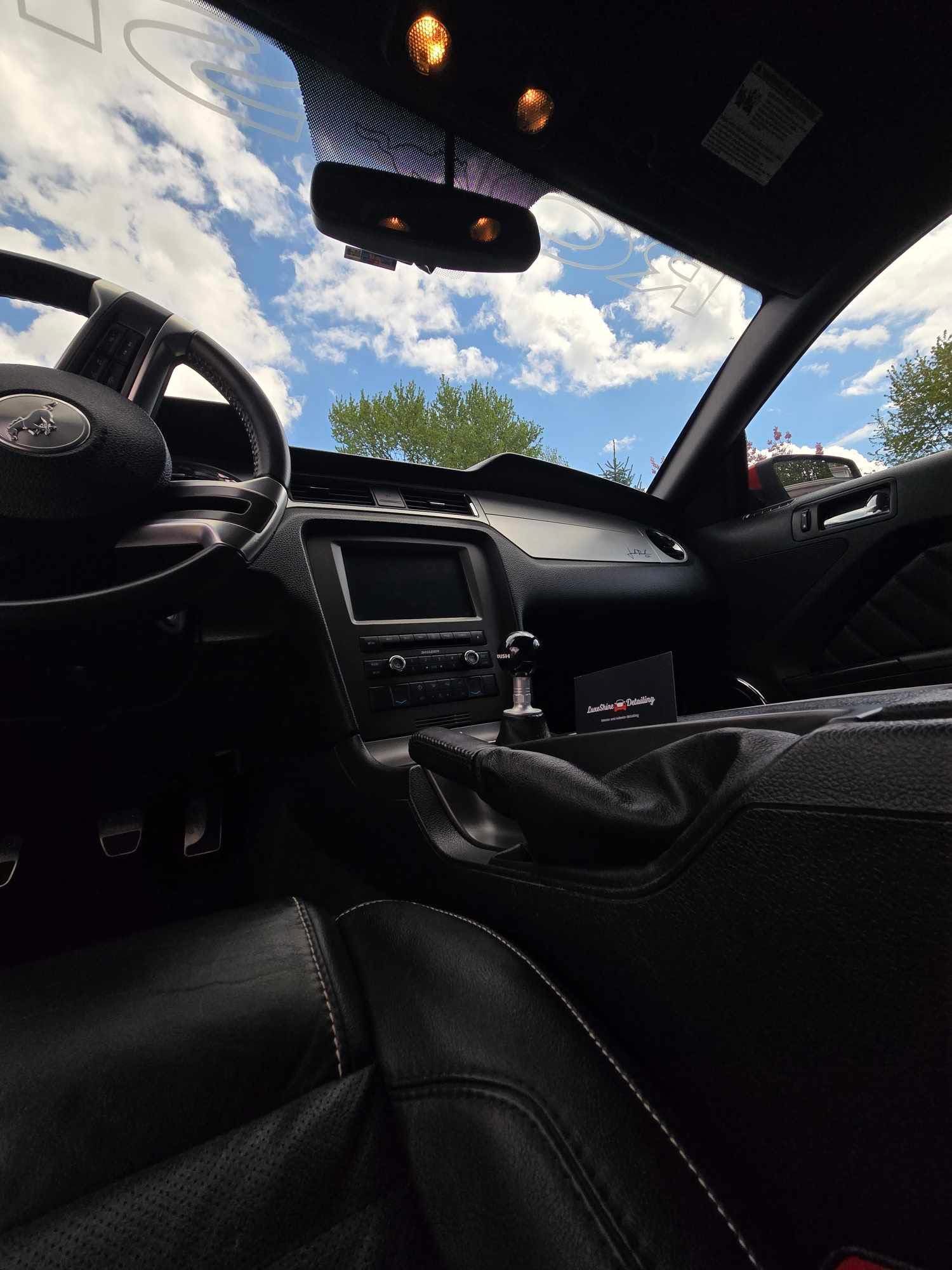 Mustang interior detail with clean dash, console, and leather seats